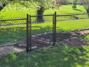 Photo of a chain link fence with walk gate