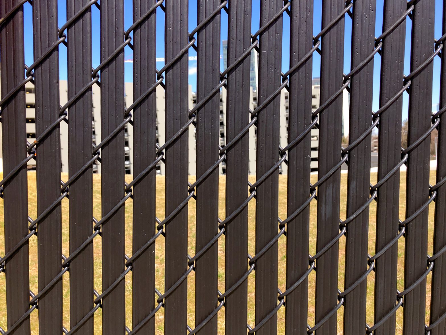 Photo of a slatted chain link fence