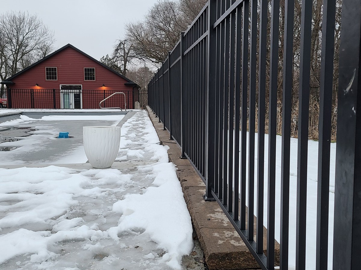 Photo of an aluminum fence installation in winter in Nebraska